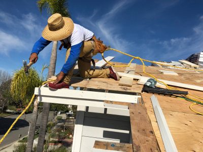 professional working on roof of home